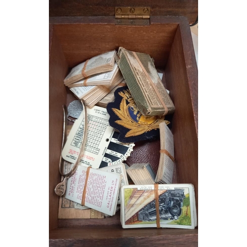 133 - A box of miscellaneous items including Dutch cards, cigarette cards, buttons, badges etc