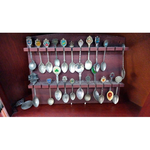 143 - A good selection of tourists collectors spoons etc on racks