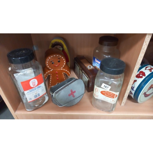 167 - A good selection of tins, vintage sweet shop bottles/jars and a pottery gingerbread man biscuit hold... 