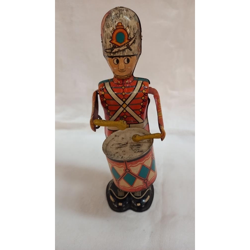 208 - Vintage tinplate clockwork Marx toys George the drummer boy and painted wood Grenadier guard skittle