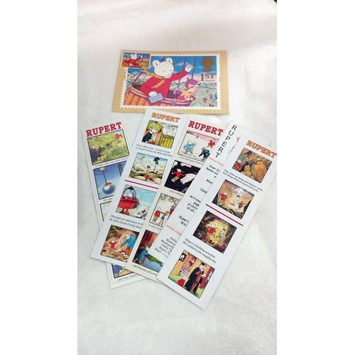 229 - A quantity of Rupert the Bear stamps etc including ingot puzzle game etc