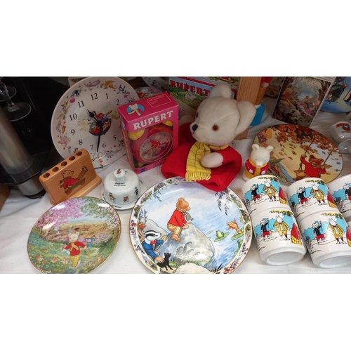 257 - A good selection of Rupert The Bear collectables including pottery, books & glove puppet etc. COLLEC... 