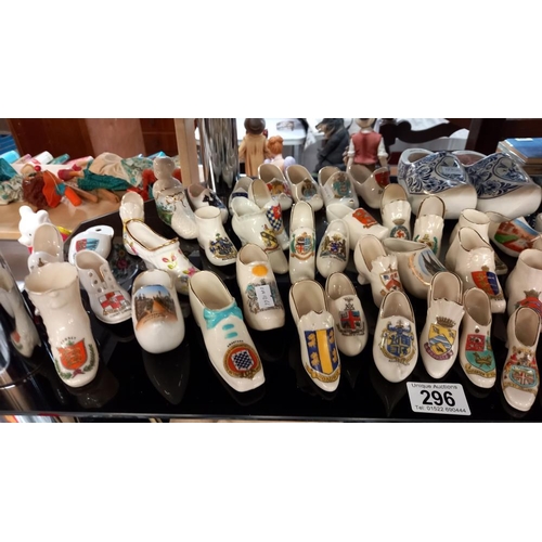 296 - A large collection of crested china shoe ornaments etc