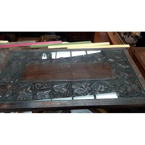 352 - An oak coffee table with carved top under glass COLLECT ONLY