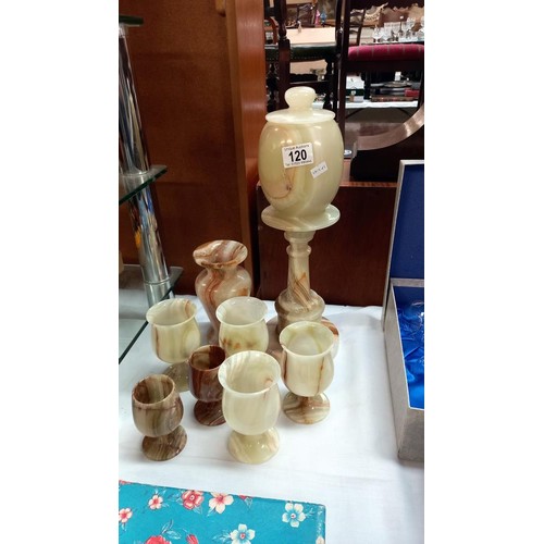 120 - A quantity of onyx items including a lamp, vase and goblets