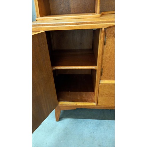 1572 - A 1950's light oak wall unit/sideboard with cupboard/drawer base with sliding cutlery tray & open ra... 