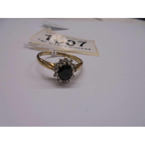 1007 - An oval diamond and sapphire 9ct gold ring, size O half, 2.2 grams.