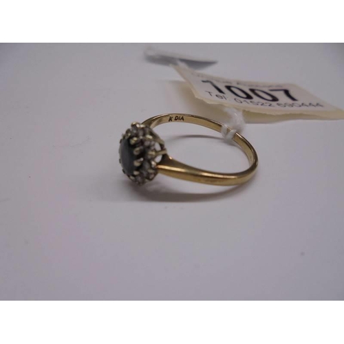 1007 - An oval diamond and sapphire 9ct gold ring, size O half, 2.2 grams.