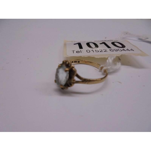 1010 - A 9ct yellow gold topaz ring, size O, 1 .6 grams.