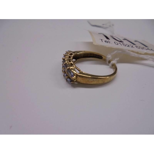 1011 - A yellow gold ring set tanzanites, size P, 2.8 grams. Marked 375