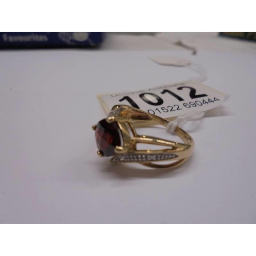 1012 - A 9ct gold ruby and diamond ring, size M, 2.9 grams.