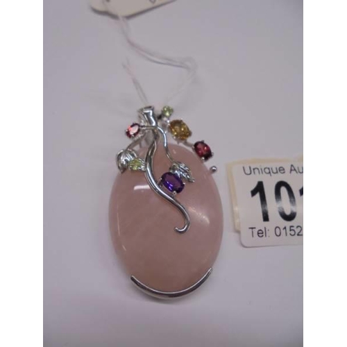 1014 - A silver and rose quartz pendant set coloured stones pendant.