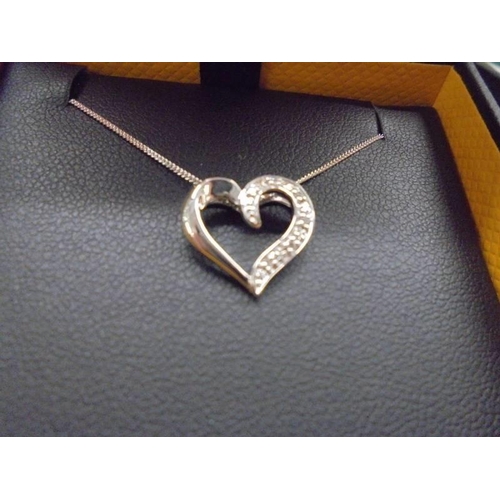 1015 - A boxed Goldsmiths white gold and diamond heart pendant, 1.85 grams.