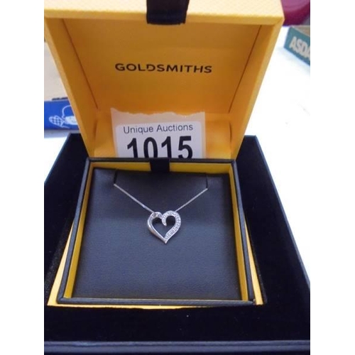 1015 - A boxed Goldsmiths white gold and diamond heart pendant, 1.85 grams.