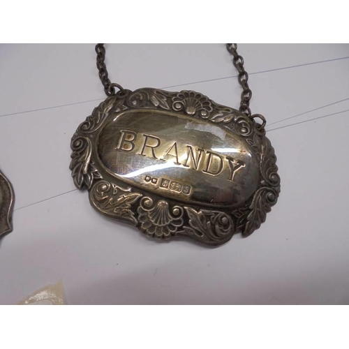 1030 - Three silver decanter labels, Brandy/Sherry/Port, 23 grams excluding chains.