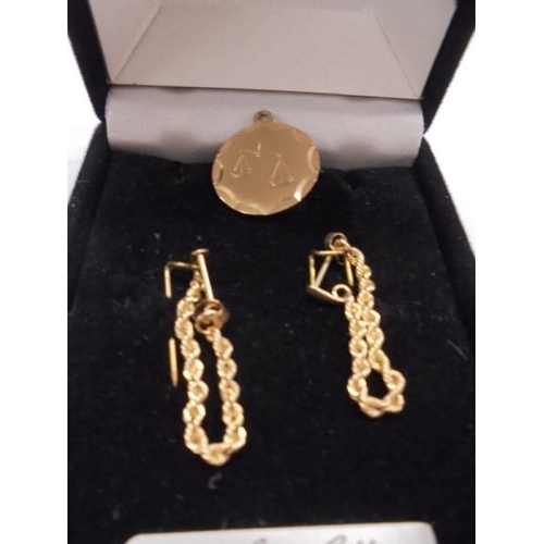 1045 - A pair of 9ct gold earrings and a 9ct gold 'Libra' pendant, 2.7 grams.