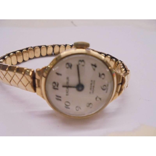 1054 - A 9ct gold ladies excaliber 17 jewel Incabloc wrist watch on 9ct gold bracelet, 17.82 grams.