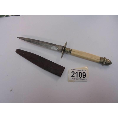 2109 - A small dagger in sheath marked Sheffield.