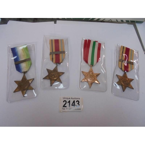 2143 - A WW1 star 99628 J A Simpson and three un-named WW! stars.