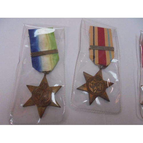 2143 - A WW1 star 99628 J A Simpson and three un-named WW! stars.