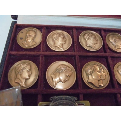 2153 - A case containing eleven Napoleon Empire coins together with other Napoleon related coins.