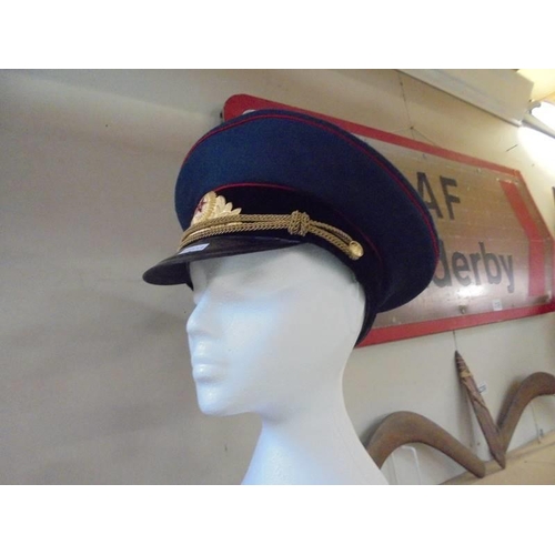 2198 - A German army generals visor cap size 61, A Russian soviet army peaked cap, size 57 and a British ar... 