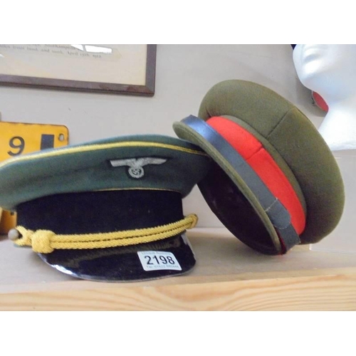 2198 - A German army generals visor cap size 61, A Russian soviet army peaked cap, size 57 and a British ar... 