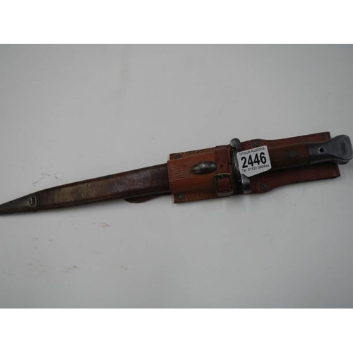 2446 - A Wilkinson bayonet in leather scabbard, blade 30.5cm.