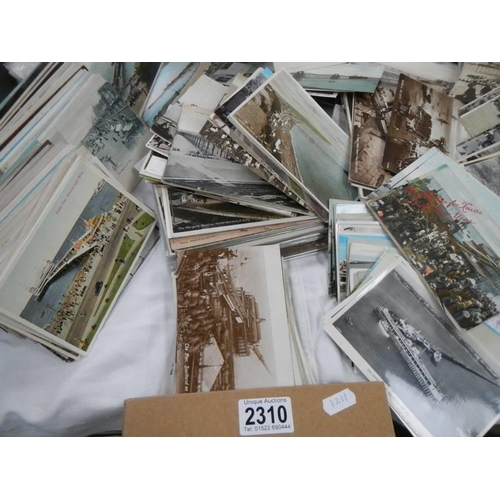 2310 - A box of vintage postcad, mostly seaside towns.