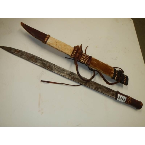 2343 - A tribal hunting knife and a small dagger.