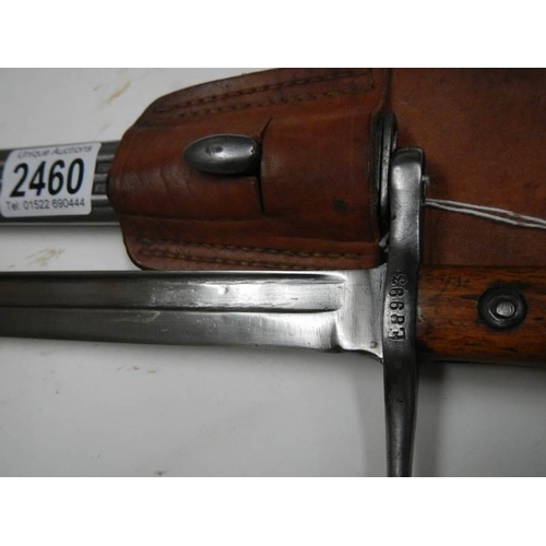 2460 - A bayonet stamped E8993 with scabbard and leather frog, blade 29.5 cm.