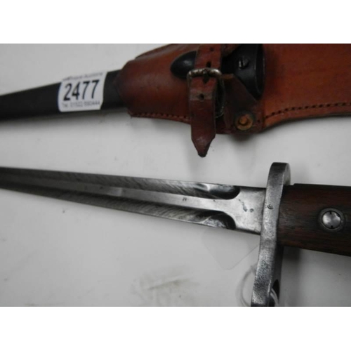 2477 - A bayonet with double edge blade with feathered engraving, blade 44 cm.