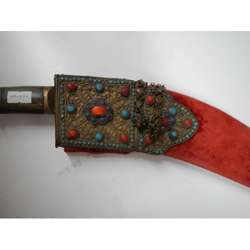 2555 - A vintage kukri with stone encrusted gilded red velvet scabbard.