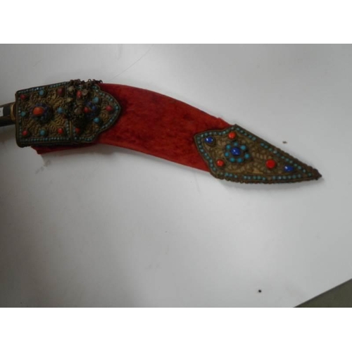 2555 - A vintage kukri with stone encrusted gilded red velvet scabbard.