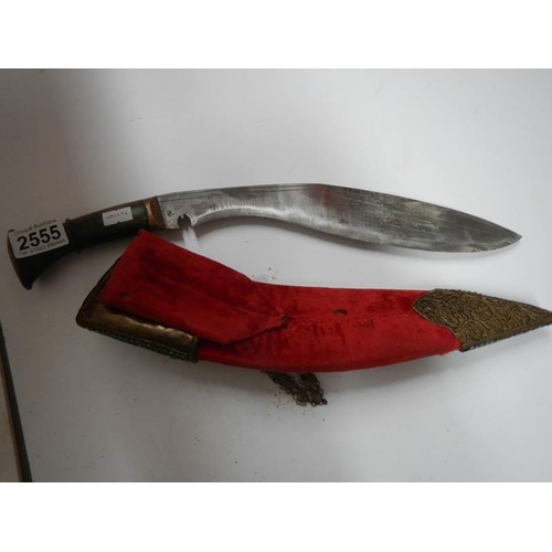 2555 - A vintage kukri with stone encrusted gilded red velvet scabbard.