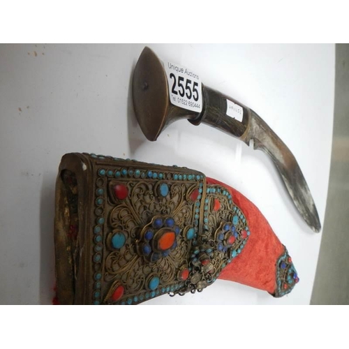 2555 - A vintage kukri with stone encrusted gilded red velvet scabbard.