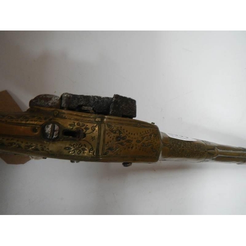 2560 - An 18/19th century Albanian Rat Tail Miquelot flint lock pistol with brass engraved stock.  COLLECT ... 