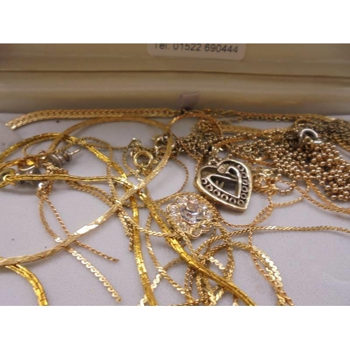 1066 - A mixed lot of yellow metal pendants and chains.