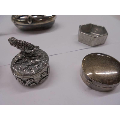 1080 - A silver pill box with elephant atop and a collection of silver plate pill boxes.