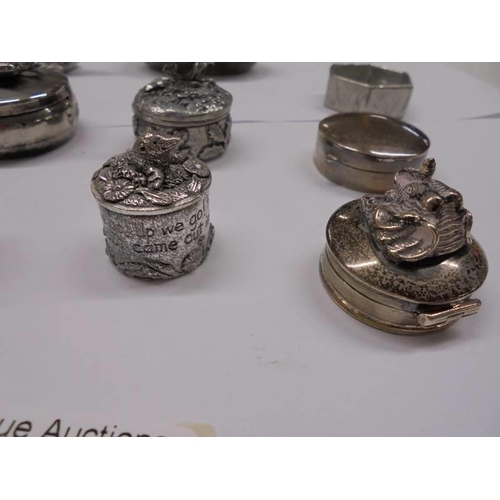 1080 - A silver pill box with elephant atop and a collection of silver plate pill boxes.