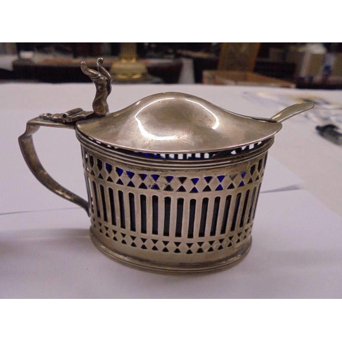 1090 - A silver salt and mustard pot with blue glass liners (mustard liner chipped).