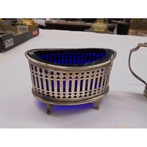 1090 - A silver salt and mustard pot with blue glass liners (mustard liner chipped).