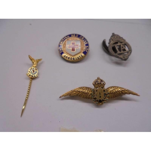 1097 - A 9ct gold RAF wings brooch, A TA badge No. 258582, a stick pin and a Red Cross badge.