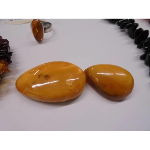 1123 - An amber necklace, amber bracelet, amber set ring, amber fish on rock and two amber stones.