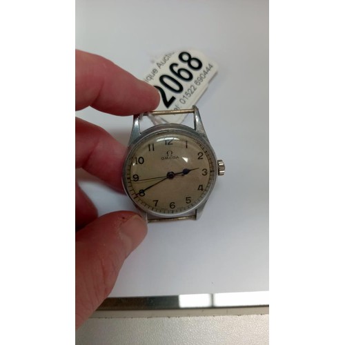 2068 - A military WW2 Omega wrist watch, (no strap) in working order.