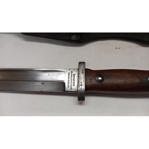 2413 - A bayonet in scabbard.