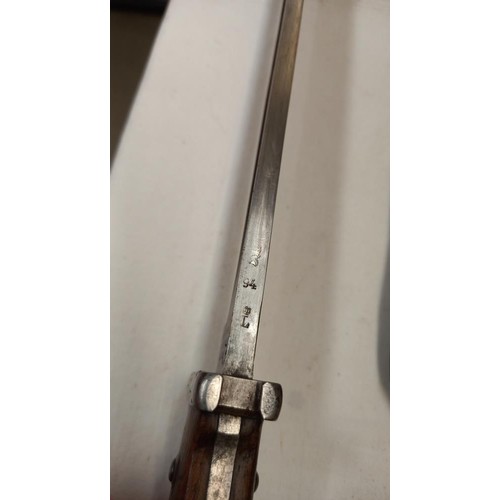 2413 - A bayonet in scabbard.