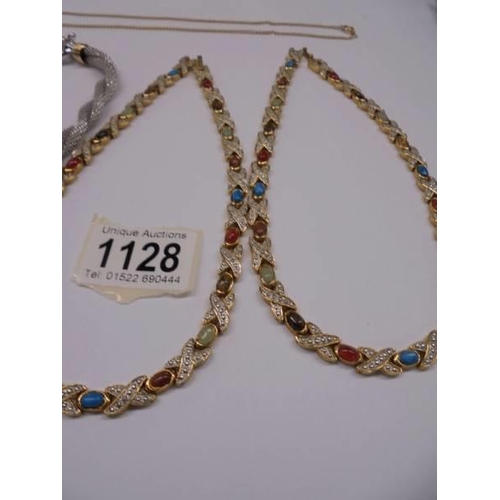 1128 - Four good quality necklaces and a yellow metal chain.