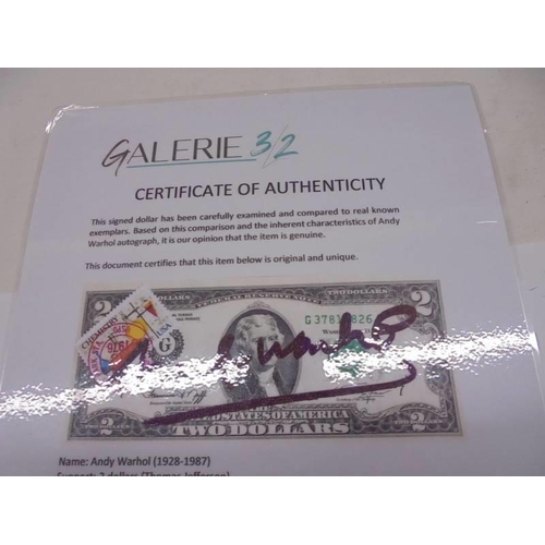 1139 - An Andy Warhol signed two dollar bill in perspex frame with certificate of authenticity.