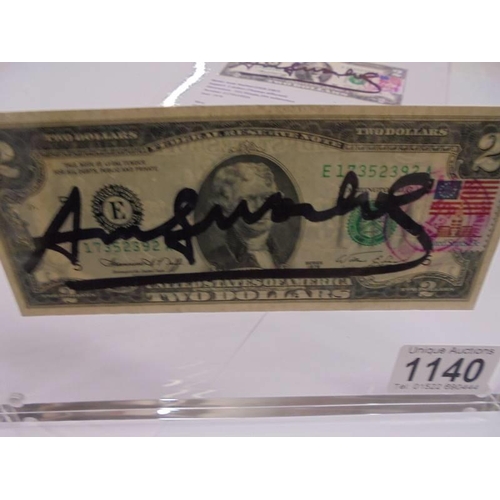 1140 - An Andy Warhol signed two dollar bill in perspex frame with certificate of authenticity.